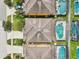 Aerial shot showcasing backyard pools, well-maintained roofs, and verdant landscaping throughout the neighborhood at 2551 Dharma Cir, Kissimmee, FL 34746