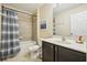 Full bathroom featuring a shower-tub combination with a dark vanity at 2551 Dharma Cir, Kissimmee, FL 34746