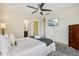 Bright bedroom with a ceiling fan, TV, dresser, ensuite bathroom, and walk-in closet at 2551 Dharma Cir, Kissimmee, FL 34746