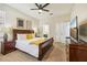 The bedroom includes a dark wood bed frame, a TV, and a closet with white doors at 2551 Dharma Cir, Kissimmee, FL 34746