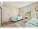 Bedroom featuring two twin beds, a window, and a decorative mirror at 2551 Dharma Cir, Kissimmee, FL 34746