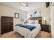This stylish bedroom features a large bed, a dresser, and a ceiling fan at 2551 Dharma Cir, Kissimmee, FL 34746