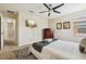 Bright bedroom with a ceiling fan, TV, and a dresser topped with fresh white towels at 2551 Dharma Cir, Kissimmee, FL 34746
