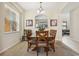 Traditional dining room with a wood table, seating for six, and natural light at 2551 Dharma Cir, Kissimmee, FL 34746