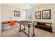 This game room features a foosball table, desk space, and lively cartoon art at 2551 Dharma Cir, Kissimmee, FL 34746