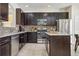 Stylish kitchen featuring stainless steel appliances, a mosaic backsplash, and ample counter space at 2551 Dharma Cir, Kissimmee, FL 34746