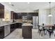 Well-appointed kitchen featuring stainless steel appliances, dark cabinets, and an island at 2551 Dharma Cir, Kissimmee, FL 34746