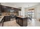 Modern kitchen with an island, stainless steel appliances, and dark wood cabinets at 2551 Dharma Cir, Kissimmee, FL 34746