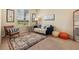 Cozy living room featuring a comfortable sofa, patterned rug, and a large window at 2551 Dharma Cir, Kissimmee, FL 34746
