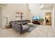Open-concept living room with tile flooring, a comfortable sofa, and a view of the second story at 2551 Dharma Cir, Kissimmee, FL 34746
