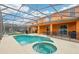Inviting screened-in pool and spa with ample patio space, perfect for outdoor entertaining and relaxation at 2551 Dharma Cir, Kissimmee, FL 34746