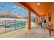 A screened-in pool with a dining area under a covered lanai and a safety fence at 2551 Dharma Cir, Kissimmee, FL 34746