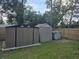 Spacious backyard with two storage sheds and a wooden fence at 261 N Third St, Winter Springs, FL 32708