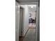 A hallway that leads to the living room, complete with hardwood flooring and a light gray rug at 261 N Third St, Winter Springs, FL 32708