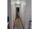 Hallway with light walls and carpet runner, with doorways leading to other rooms at 261 N Third St, Winter Springs, FL 32708