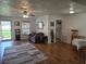 Cozy living room featuring wood flooring, a ceiling fan, and bright natural lighting at 261 N Third St, Winter Springs, FL 32708