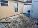 Small backyard featuring white gravel, a grill, and adjacent neutral-colored buildings at 281 San Gabriel St, Winter Springs, FL 32708