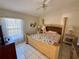 Comfortable bedroom featuring a ceiling fan, a large window, and a plush bed for a restful retreat at 281 San Gabriel St, Winter Springs, FL 32708