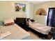Cozy bedroom equipped with 2 twin beds, a small desk, and window with black-out curtains, ideal for restful nights at 281 San Gabriel St, Winter Springs, FL 32708