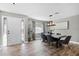 Bright dining area featuring tile floors, a contemporary light fixture, and a decorative front door at 322 Nelson Ave, Longwood, FL 32750