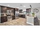 Modern kitchen featuring stainless steel appliances, granite countertops, and dark wood cabinetry at 322 Nelson Ave, Longwood, FL 32750