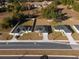Aerial view of three homes with neighborhood road access and adjacent landscape at 325 Marion Oaks Trail, Ocala, FL 34473