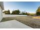 Large, fenced backyard with a concrete slab, providing ample space for outdoor activities at 325 Marion Oaks Trail, Ocala, FL 34473