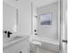 Bathroom with modern white tile, bathtub, and black fixtures at 325 Marion Oaks Trail, Ocala, FL 34473