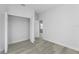 A bright bedroom with light wood flooring, a closet, and an en-suite bathroom at 325 Marion Oaks Trail, Ocala, FL 34473