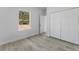 A bright bedroom with light wood flooring, a window with a view, and closet with folding doors at 325 Marion Oaks Trail, Ocala, FL 34473