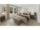 Bright bedroom featuring a neutral color scheme, upholstered headboard, and serene natural light at 325 Marion Oaks Trail, Ocala, FL 34473