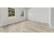 Bedroom featuring two windows with outside views and light wood-look flooring at 325 Marion Oaks Trail, Ocala, FL 34473
