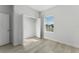 A bright bedroom with light wood flooring, a closet, and a large window that provides natural light at 325 Marion Oaks Trail, Ocala, FL 34473