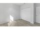 A bright bedroom with light wood flooring and a closet with folding doors at 325 Marion Oaks Trail, Ocala, FL 34473