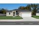 Charming single-story home with a well-manicured lawn and a two-car garage in a serene neighborhood at 325 Marion Oaks Trail, Ocala, FL 34473