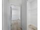 Hallway entrance to bathroom featuring a large, open closet at 325 Marion Oaks Trail, Ocala, FL 34473