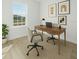 Stylish home office with a desk, chairs, and natural light creates an inviting workspace at 325 Marion Oaks Trail, Ocala, FL 34473