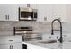 Close-up of kitchen features, white countertops, and stainless steel appliances at 325 Marion Oaks Trail, Ocala, FL 34473