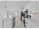 Well-equipped kitchen with stainless steel appliances and island, seamlessly connected to living spaces at 325 Marion Oaks Trail, Ocala, FL 34473