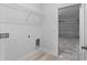Bright laundry room with wood-look floors, wire shelving, and garage access at 325 Marion Oaks Trail, Ocala, FL 34473