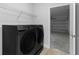 Laundry room featuring Samsung washer and dryer with shelving and access to the garage at 325 Marion Oaks Trail, Ocala, FL 34473