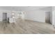 Spacious living room featuring modern kitchen, dining and light wood flooring at 325 Marion Oaks Trail, Ocala, FL 34473