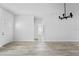 Bright, open-concept living room featuring modern light fixtures and light wood-look flooring at 325 Marion Oaks Trail, Ocala, FL 34473