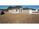 Side view of home featuring minimalist landscaping and a white front door at 325 Marion Oaks Trail, Ocala, FL 34473