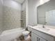Bright bathroom featuring tile shower surround, white vanity, and modern fixtures at 333 Bahia Cir, Longwood, FL 32750