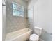 Bright bathroom featuring a tub with unique tiling, complementing the modern fixtures and finishes at 333 Bahia Cir, Longwood, FL 32750