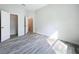 Bright bedroom with wood-look tile floors, offering access to a walk-in closet and other rooms at 333 Bahia Cir, Longwood, FL 32750