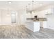 Spacious kitchen with white cabinetry, stainless appliances, and an open floor plan at 333 Bahia Cir, Longwood, FL 32750