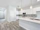 Bright kitchen with white cabinets, pendant lights, and stainless steel appliances at 333 Bahia Cir, Longwood, FL 32750