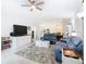 Open-concept living room, adjacent to kitchen and dining area, with neutral decor at 406 Sandbar Ave, Haines City, FL 33844